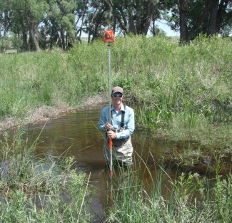 Michael Fitzgerald conducting aquatic sampling with a Prism Pole