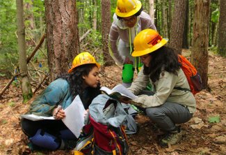 Sydne Record with students in the field